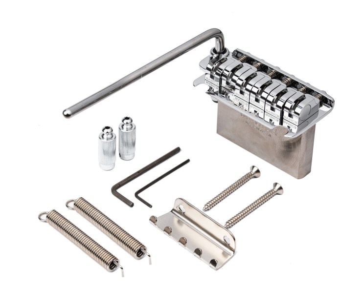 A collection of guitar bridge parts including a chrome tremolo system, springs, screws, and tools.