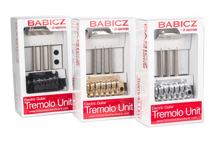 Three boxes of Babicz Electric Guitar Tremolo Units in black, gold, and silver finishes.