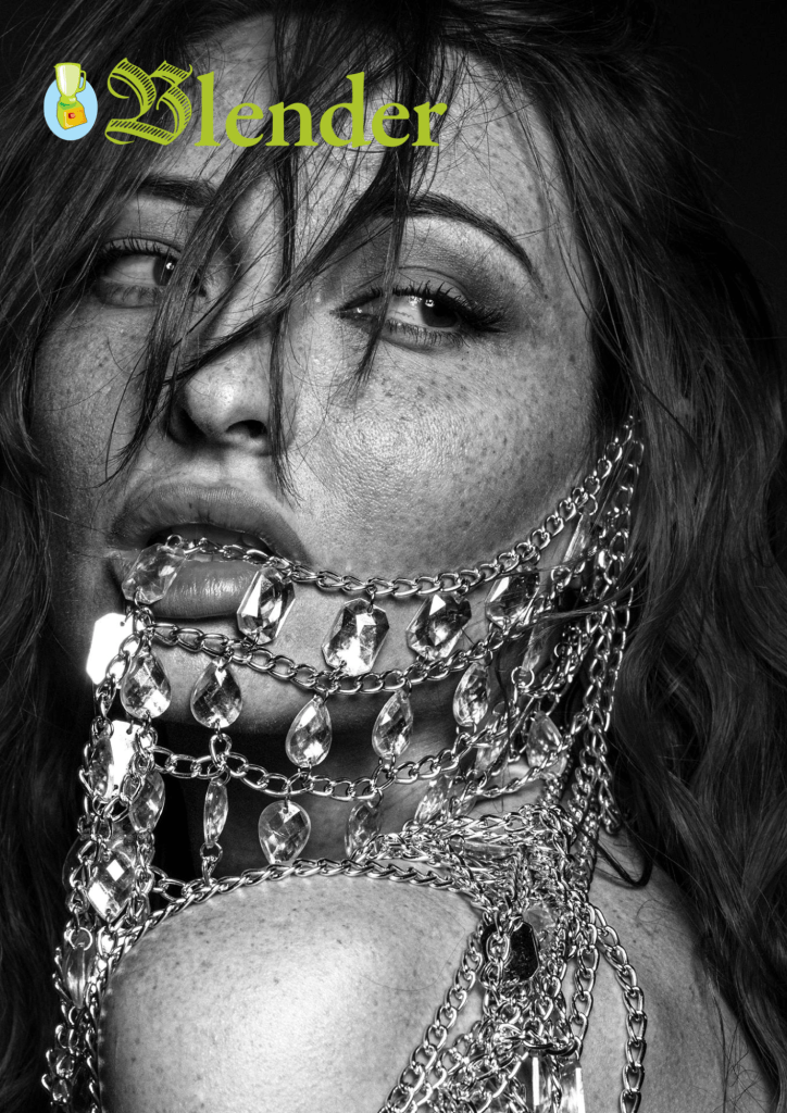 Close-up of a model with long hair adorned with glistening chains and crystals, shot in black and white to emphasize details.